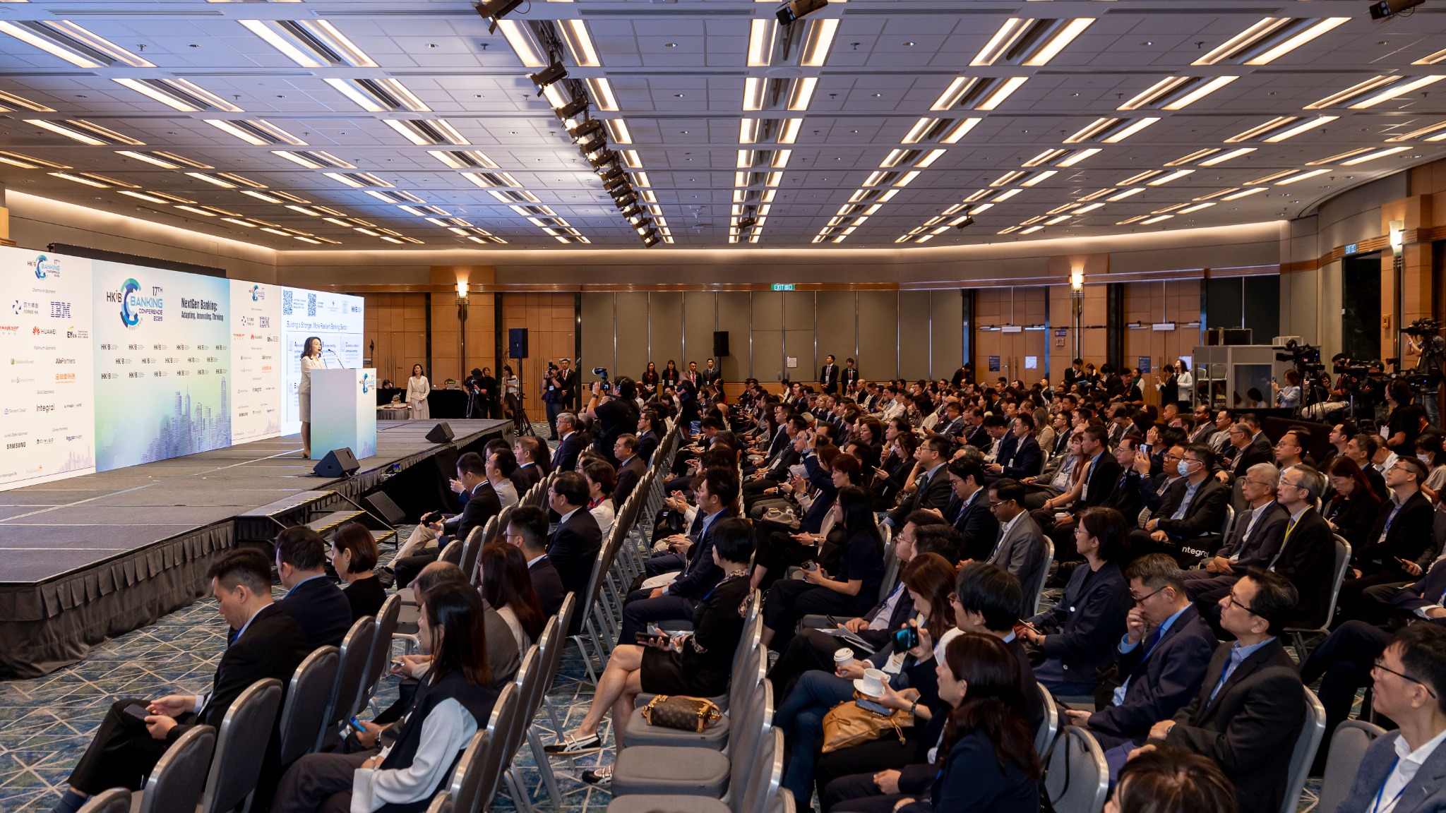 Wide conference audience shot showing strong attendance and event scale